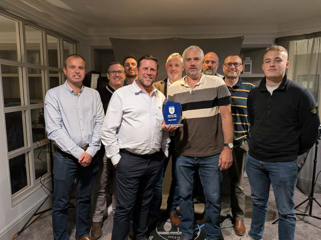Mepal & Sutton FC representatives holding the Cambridgeshire FA Grassroots Club of the Year 2026 trophy